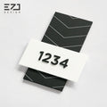 Modern geometric acrylic hotel room number sign with dark gray layered design and Braille
