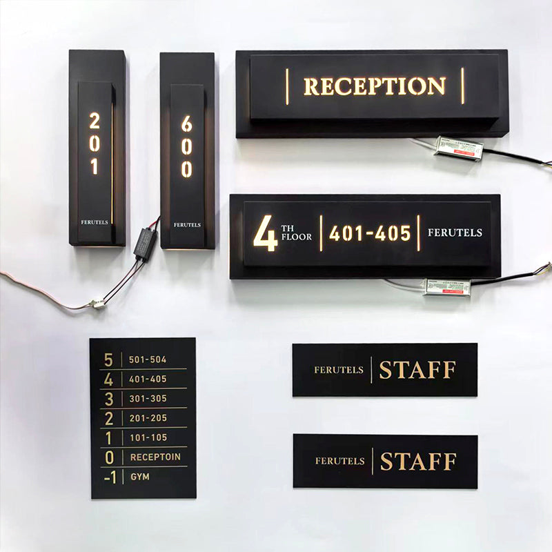 Matching black room, reception, directory, and staff signs