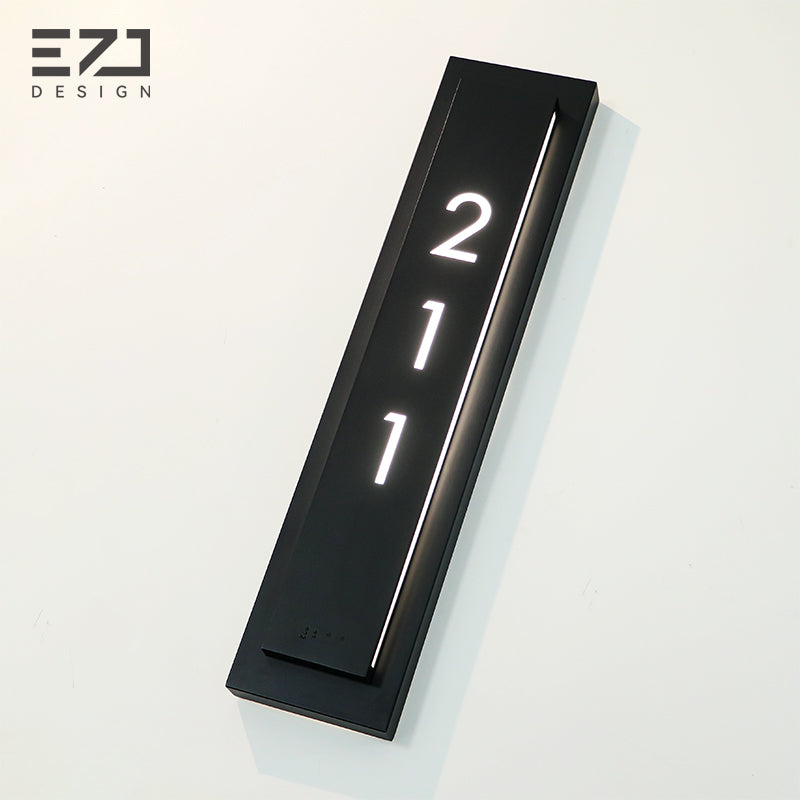 Angled view of a double-layer black hotel room number sign