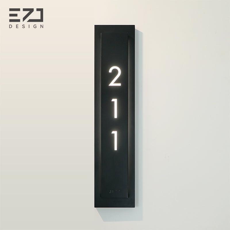 Minimalist black hotel room number sign with room numbers and braille
