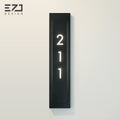 Minimalist black hotel room number sign with room numbers and braille