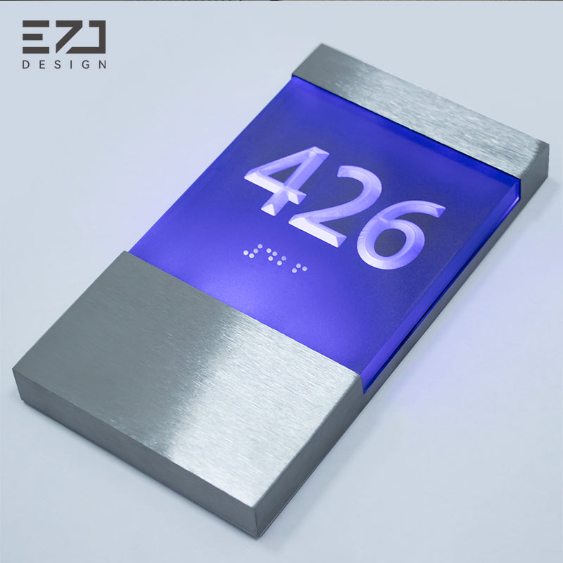 Illuminated raised-number hotel room sign with Braille